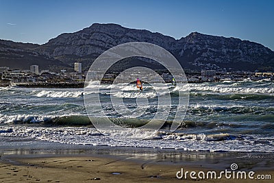 Windsurfers and surfers in action Stock Photo