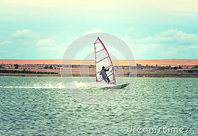 Windsurfing Sport sailing water active leisure Windsurfer on lake summer day Stock Photo