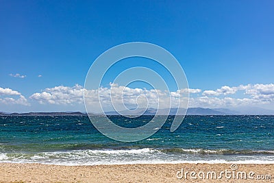 Windy sandy beach, rough sea, blue sky with clouds background Stock Photo