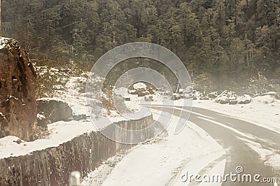 Windy snowy foggy slippery muddy flat step himalayan mountain road in winter. Leh Manali Highway, Jammu and Kashmir, India, Asia Editorial Stock Photo