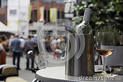 Wine bottle in cooler with a glass rose Stock Photo