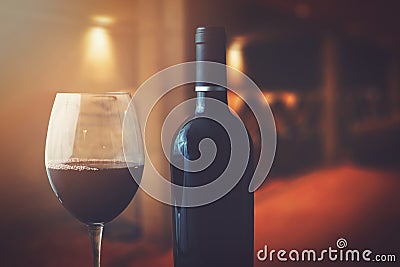 Wine bottle and glass in wine cellar Stock Photo