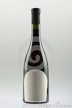 Wine bottle with sloping sides and wide bottom, empty label Stock Photo