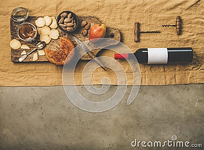 Wine bottle, vintage corkscrews and appetizers board, copy space Stock Photo