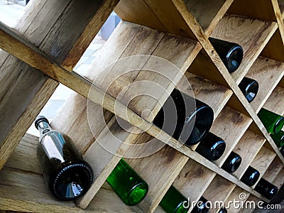 Wine bottles lie on the shelves in the form of a rhombus Stock Photo