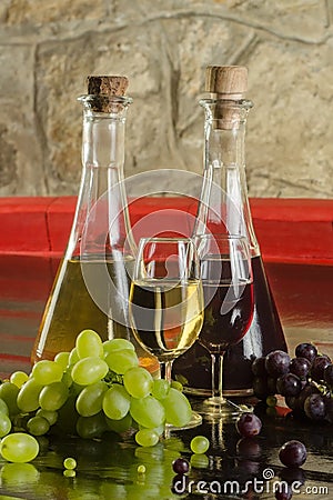 Wine bottles, wine glasses and grapes Stock Photo