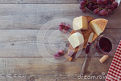 Wine, cheese and grapes on wooden table. View from above with copy space Stock Photo