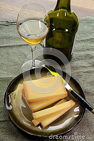 Wine and cheese pairing, local Comte cheese produced in the Franche-Comte region and special and characteristic yellow wine vin Stock Photo