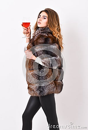 Wine culture concept. Woman drink wine. Girl fashion makeup wear fur coat hold glass alcohol. Elite leisure. Reasons Stock Photo