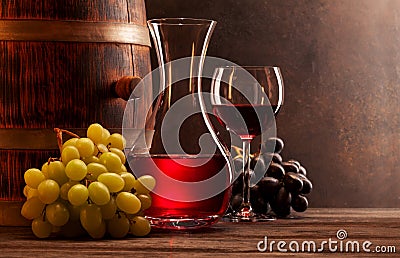 Wine decanter, glass of red wine and old wooden barrel Stock Photo