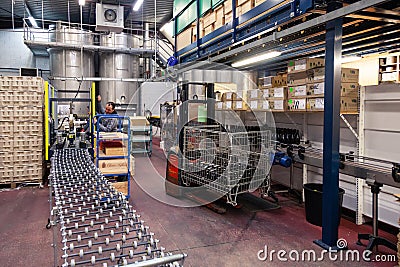 Wine factory, production room, warehouse, shelving, shelves with boxes, empty wine bottles in the package. The concept of the Editorial Stock Photo