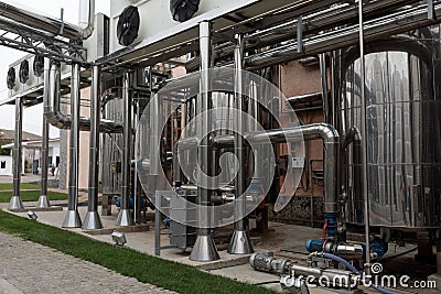 Wine Fermenting in huge vats. modern wine production plant Stock Photo