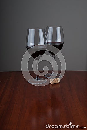 Wine glases on glossy woden background Stock Photo