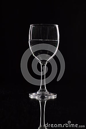 Wine glass on a black background with contour lighting. Studio shot Stock Photo