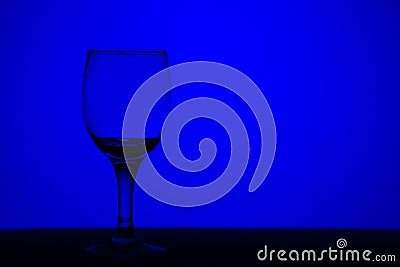 Wine glass blue monochrome background Stock Photo