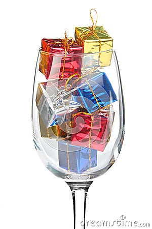 Wine glass full of Christmas gifts Stock Photo