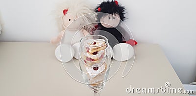 Wine glass with heart shaped cookies near couple of soft toys Stock Photo