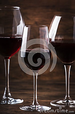 Wine glass. Selection of red wines on wine tasting. Dry, semi-dry, sweet red wine on old wooden table background. Copy space Stock Photo