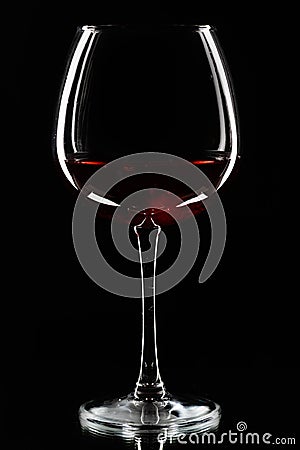 Wine glasses of different shapes and a bottle on a black background. A contour photo Stock Photo