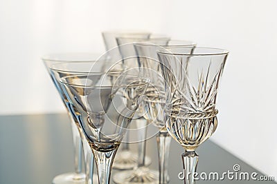 Decorative wine and martini glasses are set up in verticle rows displaying beautiful details of the glass Stock Photo