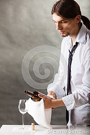 Wine steward fills glass. Stock Photo