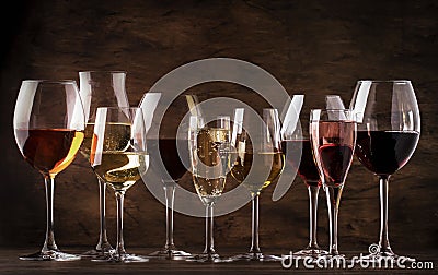 Wine tasting concept, still and sparkling wines. Red, white wine, rose and champagne in wine glasses on vintage wooden table Stock Photo