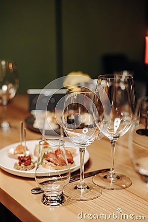 Wine tasting experience in the rustic cellar and wine bar: red wine glass and collection of excellent wines on the Stock Photo