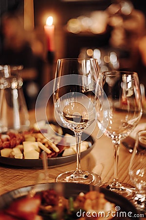 Wine tasting experience in the rustic cellar and wine bar: red wine glass and collection of excellent wines on the Stock Photo