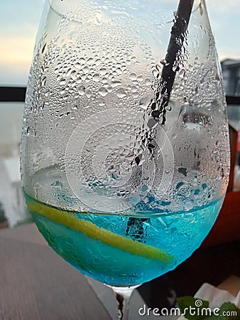 wineglass , lemon, blue Lagoon, drops Stock Photo