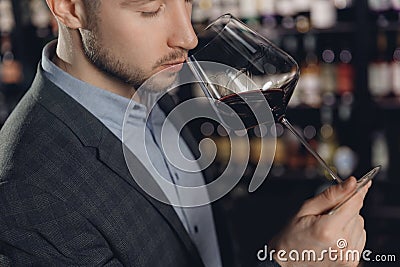 Winemaker sommelier smelling red wine aroma in glass Stock Photo