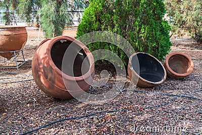 Winemaking earthenware. Ancient, historical clay vessels for wine preparation. Wine making barrels Stock Photo