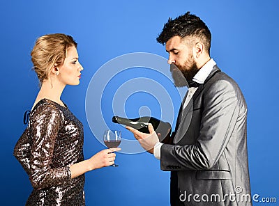 Winetasting and celebrating concept. Man with beard, woman in dress Stock Photo