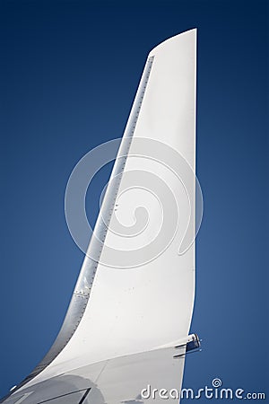 Wing of an airliner plane in flight. Blue sky. Stock Photo