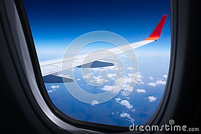 Wing airplane with blue sky from window,Beautiful blue sky view from commercial airplane window Stock Photo