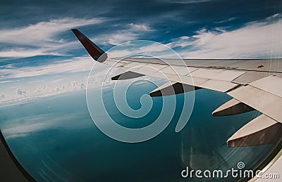Wing of an airplane over the gulf of Thailand Stock Photo
