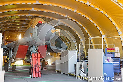 Wing military fighter with folded wings in the garage of the hangar on service repair Stock Photo