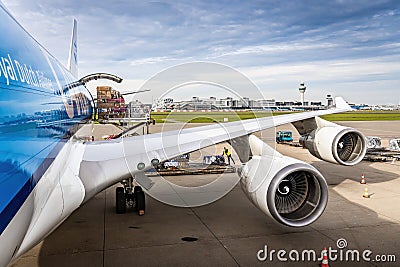 Wing view of a large jet airplane. Boeing 747 loading cargo via rear door. Editorial Stock Photo