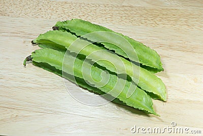 Winged Bean or Princess Bean on wooden chopping block Stock Photo