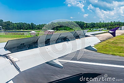 The wings of an airplane during landing provide lift and resistance to stop Stock Photo