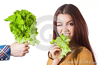 Winking girl with lettuce Stock Photo