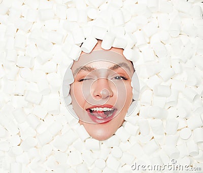 Winking model posing in mashmallow Stock Photo