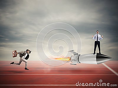 Winner businessman over a fast rocket. Concept of business competition Stock Photo