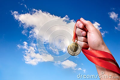 Winner with gold medal in hand Stock Photo