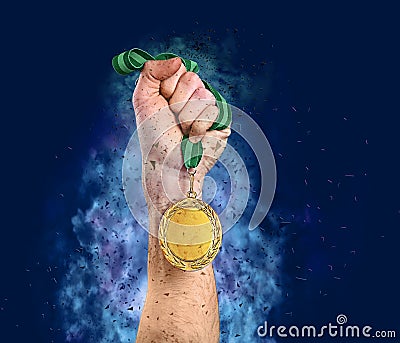 Winner raising hand with gold medal surrounded by fume and shatters on blue background, closeup Stock Photo