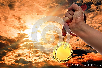 Winner raising hand with gold medal up to sky, closeup. Space for text Stock Photo