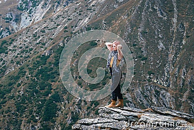 Winner. Success concept. Hiker girl after hiking to mountain top. copy space. adventure Romania Stock Photo