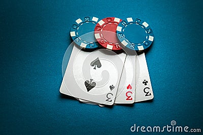 A winning combination of three of a kind or set of cards on a poker table in a club. Successful poker game concept with playing Stock Photo