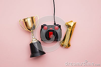 Winning gamer. A retro games joystick with a gold winning trophy Stock Photo