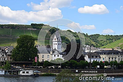 Winningen, Germany - 06 25 2020: central waterfront of Winningen with a ship Editorial Stock Photo