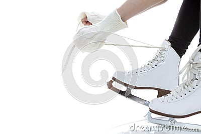 Winter Activity. Closeup of Teenager Girl Hands Lacing Up Ice Skates Against White Stock Photo